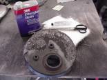 Fiberglass kits are sold at any Auto Parts Store.  Mix the resin according to the directions with the hardner. Cut pieces of fiberglass mat to fit the area you want 'glassed in.  Use an old cheap paint bruch to completely soak the fiberglass mat in the resin. Use the brush to help smooth out the pieces of fiberglass mat over the area and let dry. Sand smooth when dry and paint with flat black spray paint.  Noone will ever be able to tell it didn't come that way from the Factory. 