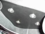 This is a shot INSIDE the saddle bag/ side cover. To stiffen up the saddle bag I cut an old windshield into the shape of the back side of the saddle bag. I used a heat gun to take most of the curve out of the old windshield piece. Then I painted it flat black so you hardly notice it is there.  I drilled holes through the plexiglass and the back of the saddle bag for mounting.  The fender washers give it extra support so the plexiglass doesn't crack around the holes.  The button head bolts are nice so I don't hang the skin on my hands like I would with hex head bolts while reaching inside.  The little details like this are what make the Custom bike either usable or just a pain in the butt to own. 